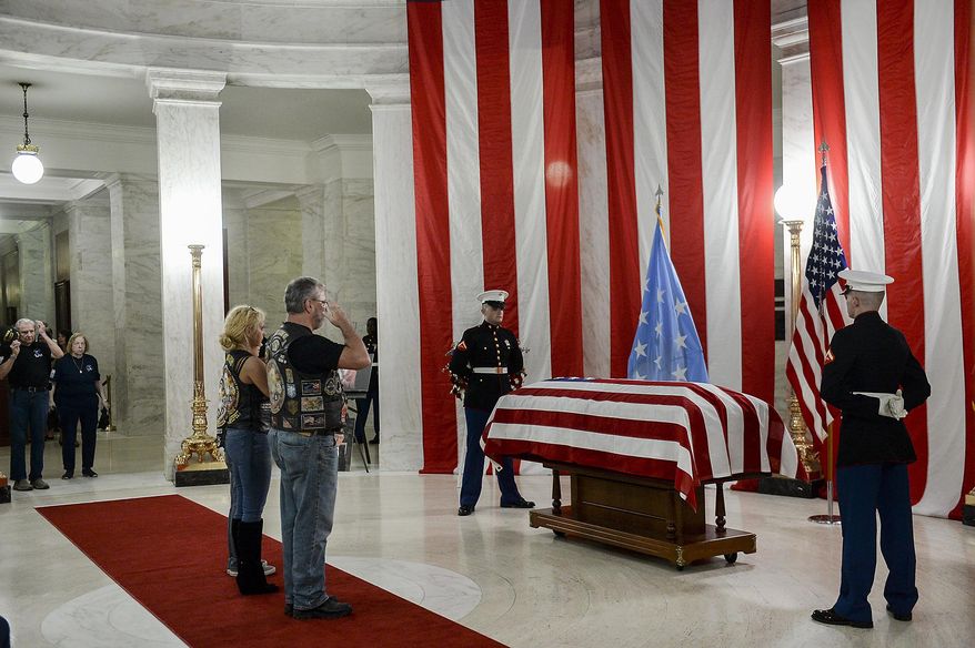 People salute the casket of Hershel &amp;quot;Woody&amp;quot; Williams set up in the first floor rotunda of the West Virginia State Capitol in Charleston, W.Va., for visitation on Saturday, July 2, 2022. Williams, 98, a West Virginian who was the last living Medal of Honor recipient from World War II, died on Wednesday, June 29. His funeral is set for Sunday, July 3. (Chris Dorst/Charleston Gazette-Mail via AP)