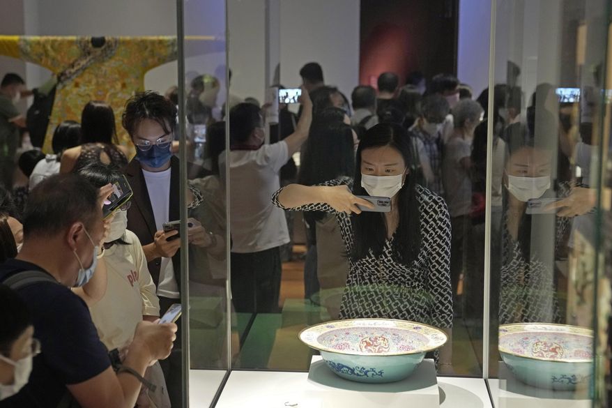 Visitors tour the Hong Kong Palace Museum during the first day open to public in Hong Kong, Sunday, July 3, 2022. It showcases more than 900 Chinese artefacts, loaned from the long-established Palace Museum in Beijing, home to works of art representing thousands of years of Chinese history and culture.   (AP Photo/Kin Cheung)
