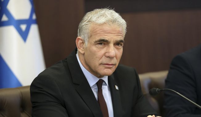 Israel&#x27;s caretaker Prime Minister Yair Lapid chairs the first cabinet meeting in Jerusalem Sunday, July 3, 2022, days after lawmakers dissolved parliament. (Gil Cohen-Magen/Pool Photo via AP)