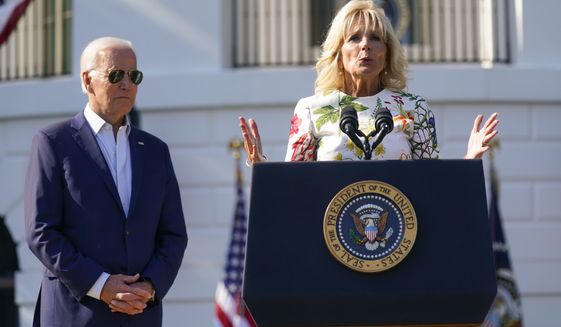 President Joe Biden listens as first lady Jill Biden speaks during a Fourth of July celebration for military families on the South Lawn of the White House, Monday, July 4, 2022, in Washington. (AP Photo/Evan Vucci)