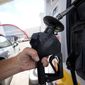 A motorist fills up a vehicle at a Shell gas station Monday, July 4, 2022, in Commerce City, Colo. (AP Photo/David Zalubowski)