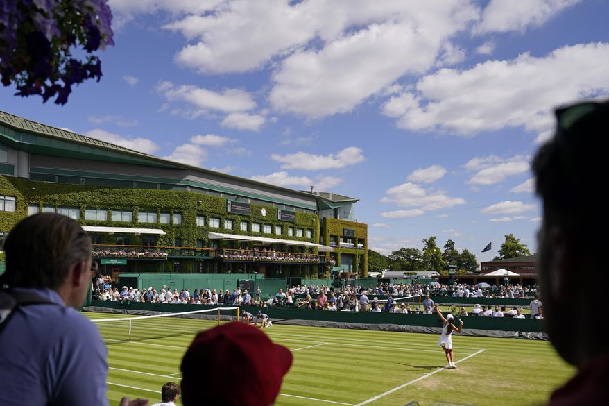 Spectators watch as Italy&#39;s Georgia Pedone serves during a Girls singles match on day eight of the Wimbledon tennis championships in London, Monday, July 4, 2022. (AP Photo/Alberto Pezzali)