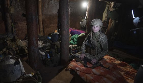 Ukrainian platoon commander Mariia rests in a trench in a position in the Donetsk region, Ukraine, Saturday, July 2, 2022. Ukrainian soldiers returning from the frontlines in eastern Ukraine’s Donbas region describe life during what has turned into a grueling war of attrition as apocalyptic. Mariia, 41, said that front-line conditions may vary depending on where a unit is positioned and how well supplied they are. (AP Photo/Efrem Lukatsky)