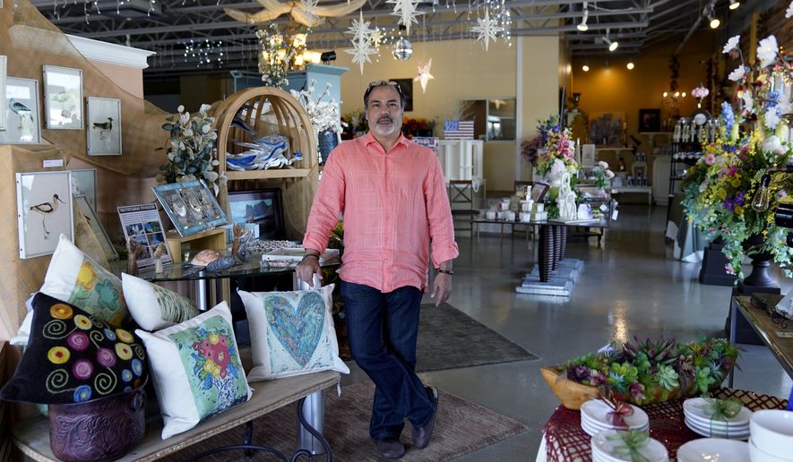 Martin Garcia, owner of gift and décor store Gramercy Gift Gallery, poses for a photo at his shop, Wednesday, June 29, 2022, in San Antonio. Landlords were forgiving about rent during the first two years of the pandemic, but now many are asking for back due rent. Meanwhile, most of the government aid programs that helped small businesses get through the pandemic have ended. (AP Photo/Eric Gay)