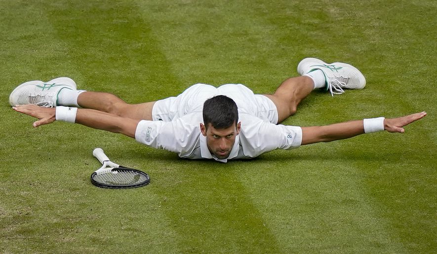 Serbia&#39;s Novak Djokovic reacts after making a passing shot to Italy&#39;s Jannik Sinner in a men&#39;s singles quarterfinal match on day nine of the Wimbledon tennis championships in London, Tuesday, July 5, 2022. (AP Photo/Alberto Pezzali)