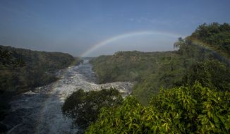 A rainbow forms in the mist at the top of the waterfalls in Murchison Falls National Park, northwest Uganda, on Feb. 22, 2020. The East Africa Crude Oil Pipeline, a controversial oil project that would connect oilfields in the park to a port in Tanzania is in breach of global environmental and human rights guidelines for banks, according to a new report by Inclusive Development International on Tuesday, July 5. (AP Photo)