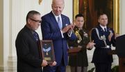 President Joe Biden presents the Medal of Honor to Staff Sgt. Edward Kaneshiro for his actions on Dec. 1, 1966, during the Vietnam War, as his son John Kaneshiro accepts the posthumous recognition during a ceremony in the East Room of the White House, Tuesday, July 5, 2022, in Washington. (AP Photo/Evan Vucci)