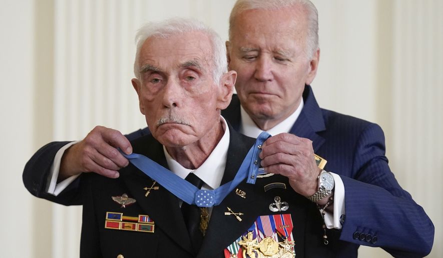 President Joe Biden awards the Medal of Honor to retired Maj. John Duffy for his actions on April 14-15 1972, during the Vietnam War, during a ceremony in the East Room of the White House, Tuesday, July 5, 2022, in Washington. (AP Photo/Evan Vucci)