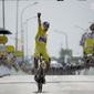 Belgium&#39;s Wout Van Aert, wearing the overall leader&#39;s yellow jersey celebrates as he crosses the finish line to win the fourth stage of the Tour de France cycling race over 171.5 kilometers (106.6 miles) with start in Dunkerque and finish in Calais, France, Tuesday, July 5, 2022. (AP Photo/Daniel Cole)
