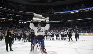 Colorado Avalanche goaltender Darcy Kuemper lifts the Stanley Cup after the team defeated the Tampa Bay Lightning in Game 6 of the NHL hockey Stanley Cup Finals on Sunday, June 26, 2022, in Tampa, Fla. (AP Photo/Phelan M. Ebenhack) **FILE**