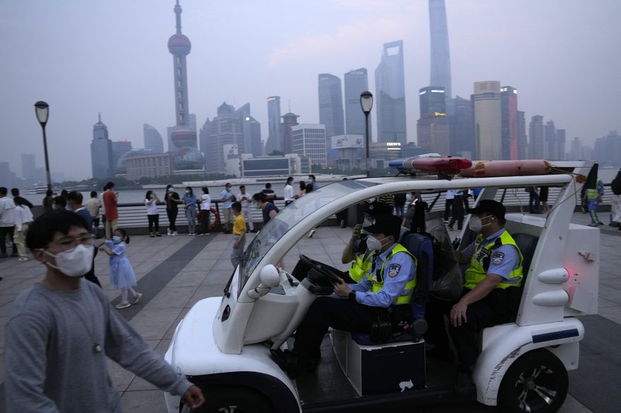 Chinese policemen patrol the bund area, Wednesday, June 1, 2022, in Shanghai. Hackers claim to have obtained a trove of data on 1 billion Chinese from a Shanghai police database in a leak that, if confirmed, could be one of the largest data breaches in history. (AP Photo/Ng Han Guan)