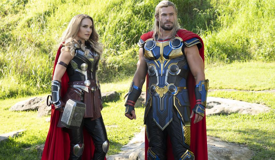 This image released by Marvel Studios shows Natalie Portman, left, and Chris Hemsworth in a scene from &amp;quot;Thor: Love and Thunder.&amp;quot; (Jasin Boland/Marvel Studios-Disney via AP)