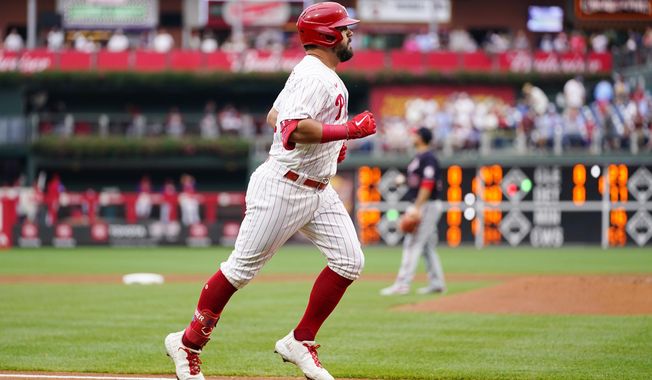 Philadelphia Phillies&#x27; Kyle Schwarber, left, rounds the bases after hitting a home run against Washington Nationals pitcher Paolo Espino during the first inning of a baseball game, Tuesday, July 5, 2022, in Philadelphia. (AP Photo/Matt Slocum)