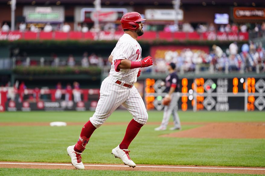Philadelphia Phillies&#39; Kyle Schwarber, left, rounds the bases after hitting a home run against Washington Nationals pitcher Paolo Espino during the first inning of a baseball game, Tuesday, July 5, 2022, in Philadelphia. (AP Photo/Matt Slocum)
