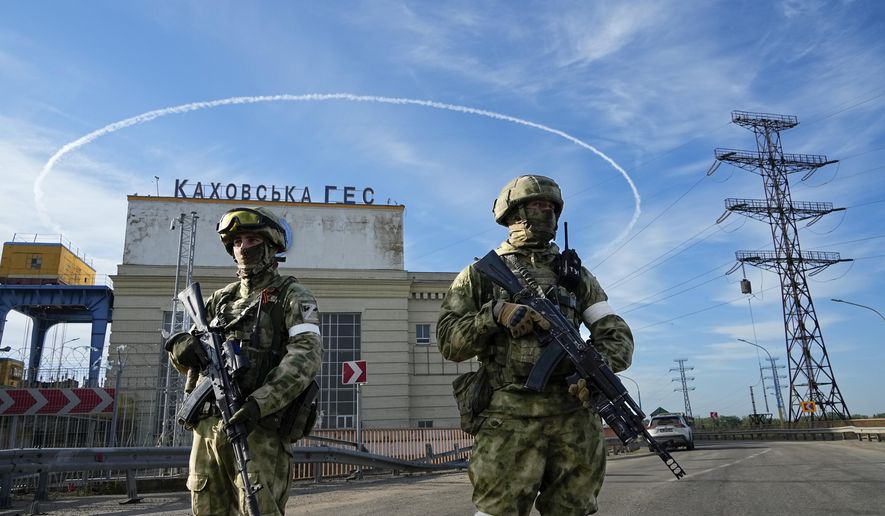 Russian troops guard an entrance of the Kakhovka Hydroelectric Station, a run-of-river power plant on the Dnieper River in Kherson region, south Ukraine, Friday, May 20, 2022. The Kherson region has been under control of the Russian forces since the early days of the Russian military action in Ukraine. This photo was taken during a trip organized by the Russian Ministry of Defense. (AP Photo, File)