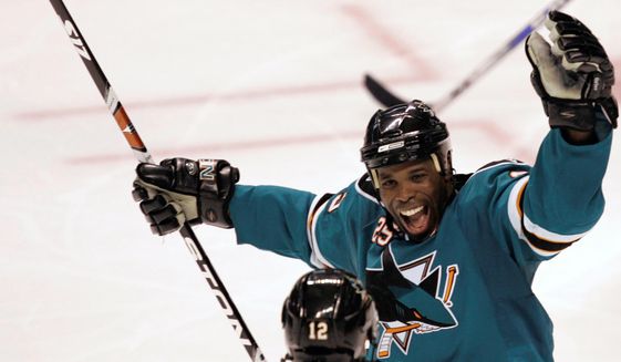 San Jose Sharks&#39; Mike Grier, top, celebrates with Patrick Marleau (12) after Marleau&#39;s third-period goal against the Columbus Blue Jackets during an NHL hockey game in San Jose, Calif., Tuesday, Oct. 14, 2008. The San Jose Sharks have hired longtime NHL forward Mike Grier to become the first Black general manager in NHL history. Grier fills the spot that opened when Doug Wilson stepped away for health reasons earlier this year in a barrier-breaking move for the league on Tuesday, July 5, 2022. (AP Photo/Marcio Jose Sanchez, File) **FILE**