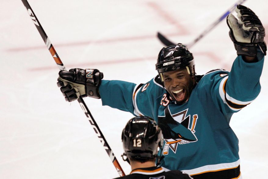 San Jose Sharks&#39; Mike Grier, top, celebrates with Patrick Marleau (12) after Marleau&#39;s third-period goal against the Columbus Blue Jackets during an NHL hockey game in San Jose, Calif., Tuesday, Oct. 14, 2008. The San Jose Sharks have hired longtime NHL forward Mike Grier to become the first Black general manager in NHL history. Grier fills the spot that opened when Doug Wilson stepped away for health reasons earlier this year in a barrier-breaking move for the league on Tuesday, July 5, 2022. (AP Photo/Marcio Jose Sanchez, File) **FILE**