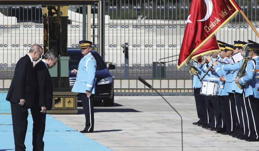 Italy&#39;s Prime Minister Mario Draghi, second left, and Turkey&#39;s President Recep Tayyip Erdogan review an honour guard prior their meeting at the Turkish Presidential palace in Ankara, Turkey, Tuesday, July 5, 2022. Draghi is on an official visit to Turkey. (AP Photo)