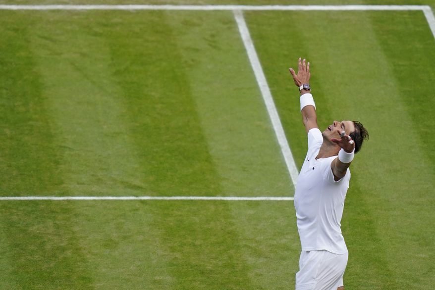 Spain&#39;s Rafael Nadal celebrates after beating Taylor Fritz of the US in a men&#39;s singles quarterfinal match on day ten of the Wimbledon tennis championships in London, Wednesday, July 6, 2022. (AP Photo/Gerald Herbert)
