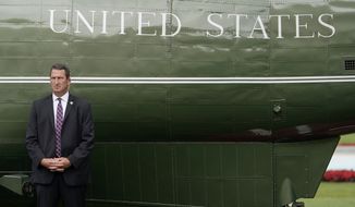 A member of the U.S. Secret Service stands guard outside Marine One, with President Joe Biden aboard, on the South Lawn of the White House, Wednesday, July 6, 2022, in Washington. Biden is traveling to Cleveland. (AP Photo/Patrick Semansky)