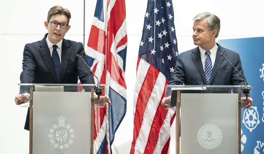 MI5 Director General Ken McCallum, left, and FBI Director Christopher Wray attend a joint press conference at MI5 headquarters, in central London, Wednesday July 6, 2022. The head of the FBI and the leader of Britain’s domestic intelligence agency raised alarms Wednesday about the Chinese government, warning business leaders that Beijing is determined to steal their technology for competitive gain. (Dominic Lipinski/PA via AP)