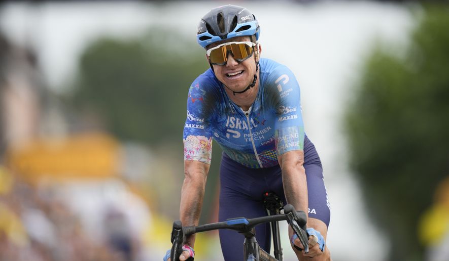 Stage winner Australia&#39;s Simon Clarke reacts after crossing the finish line of the fifth stage of the Tour de France cycling race over 157 kilometers (97.6 miles) with start in Lille Metropole and finish in Arenberg Porte du Hainaut, France, Wednesday, July 6, 2022. (AP Photo/Daniel Cole)