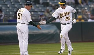 Oakland Athletics&#39; Stephen Piscotty (25) is congratulated by third base coach Darren Bush (51) after hitting a home run during the fifth inning of the team&#39;s baseball game against the Toronto Blue Jays in Oakland, Calif., Tuesday, July 5, 2022. (AP Photo/Jeff Chiu)