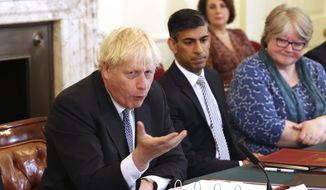 Britain&#39;s Prime Minister Boris Johnson, left, and Britain&#39;s Chancellor of the Exchequer Rishi Sunak, center, take part in a Cabinet meeting, in Downing Street, London, Tuesday, July 5, 2022. (Ian Vogler/Pool Photo via AP)