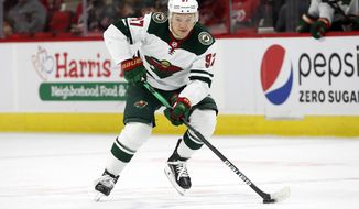 Minnesota Wild&#39;s Kirill Kaprizov (97) waits for a face-off against the Carolina Hurricanes during the first period of an NHL hockey game in Raleigh, N.C., Saturday, April 2, 2022. Minnesota Wild general manager Bill Guerin says Kirill Kaprizov remains in Russia and doing fine after state media there reported the star winger&#39;s name was linked to fraudulent military identifications. (AP Photo/Karl B DeBlaker, File) **FILE**