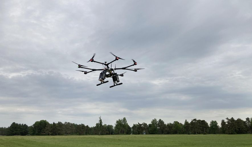 A drone flies at one of the Federal Aviation Administration’s designated drone testing sites run by nonprofit Northeast UAS Airspace Integration Research Alliance Inc., at Griffiss International Airport in Rome, N.Y., on June 11, 2021. The FAA is working to relax some aviation rules to allow some drone operators to fly their machines out of their line of sight. (AP Photo/Matt O’Brien)