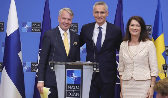 Finland&#39;s Foreign Minister Pekka Haavisto, left, Sweden&#39;s Foreign Minister Ann Linde, right, and NATO Secretary General Jens Stoltenberg attend a media conference after the signature of the NATO Accession Protocols for Finland and Sweden in the NATO headquarters in Brussels, Tuesday, July 5, 2022. (AP Photo/Olivier Matthys)