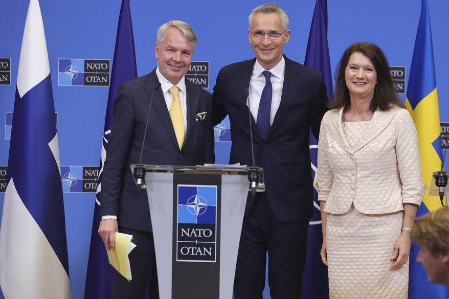 Finland&#x27;s Foreign Minister Pekka Haavisto, left, Sweden&#x27;s Foreign Minister Ann Linde, right, and NATO Secretary General Jens Stoltenberg attend a media conference after the signature of the NATO Accession Protocols for Finland and Sweden in the NATO headquarters in Brussels, Tuesday, July 5, 2022. (AP Photo/Olivier Matthys)
