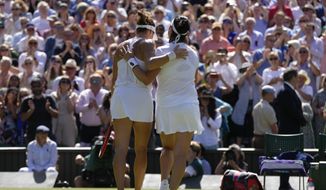Tunisia&#39;s Ons Jabeur, right, embraces Germany&#39;s Tatjana Maria after beating her in a women&#39;s singles semifinal match on day eleven of the Wimbledon tennis championships in London, Thursday, July 7, 2022. (AP Photo/Kirsty Wigglesworth)