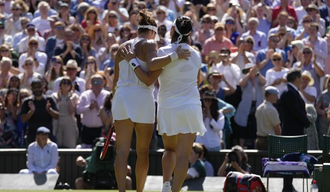 Tunisia&#x27;s Ons Jabeur, right, embraces Germany&#x27;s Tatjana Maria after beating her in a women&#x27;s singles semifinal match on day eleven of the Wimbledon tennis championships in London, Thursday, July 7, 2022. (AP Photo/Kirsty Wigglesworth)