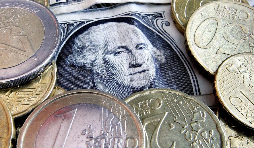 In this Feb. 27, 2008 file photo, euro coins and dollar bills are seen in Frankfurt, central Germany. The U.S. dollar has been surging in 2022, so much that it's nearly equal in value to the euro for the first time in 20 years. That trend, though, threatens to hurt American companies because their goods become more expensive for foreign buyers. If U.S. exports were to weaken as a result, so, too, would the already-slowing U.S. economy. (AP Photo/Michael Probst, File)