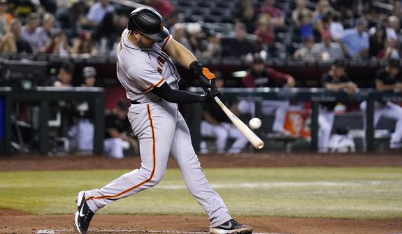 San Francisco Giants&#39; Joey Bart hits an RBI double against the Arizona Diamondbacks during the fifth inning of a baseball game Wednesday, July 6, 2022, in Phoenix. (AP Photo/Ross D. Franklin)