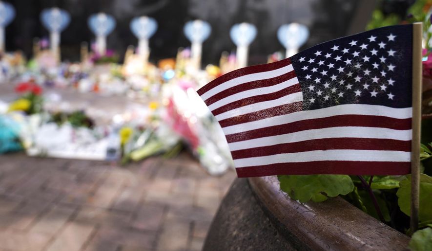 A small American flag is displayed at a memorial to the seven people killed and others injured in Monday&#39;s Fourth of July mass shooting at the Highland Park War Memorial in Highland Park, Ill., Thursday, July 7, 2022. (AP Photo/Nam Y. Huh)