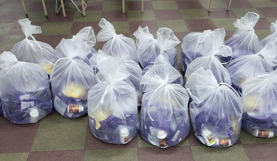 Plastic bags containing masks and medicines are placed in the border town Gimpo, South Korea, Wednesday, July 6, 2022. A South Korea activist said Thursday he launched more huge balloons carrying COVID-19 relief items toward North Korea, days after the North vowed to sternly deal with such activities and made a highly questionable claim they were a source of the virus. (Courtesy of Fighters For A Free North Korea via AP)
