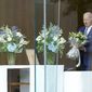 President Joe Biden holds a bouquet as he arrives to sign a condolence book at the Japanese ambassador&#39;s residence in Washington, Friday, July 8, 2022, for former Japanese Prime Minister Shinzo Abe who was assassinated on Friday while campaigning. (AP Photo/Susan Walsh)