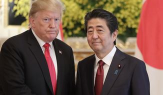 In this file photo, U.S. President Donald Trump, left, and Japanese Prime Minister Shinzo Abe pose for a photo prior to their meeting at Akasaka Palace, Japanese state guest house, in Tokyo on May 27, 2019. Mr. Trump has said he hopes to attend the funeral for the slain former prime minister. (AP Photo/Eugene Hoshiko, File)