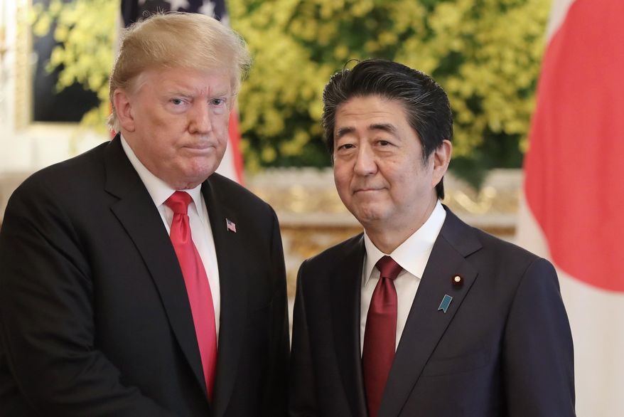 In this file photo, U.S. President Donald Trump, left, and Japanese Prime Minister Shinzo Abe pose for a photo prior to their meeting at Akasaka Palace, Japanese state guest house, in Tokyo on May 27, 2019. Mr. Trump has said he hopes to attend the funeral for the slain former prime minister. (AP Photo/Eugene Hoshiko, File)