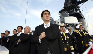 Then Japanese Prime Minister Shinzo Abe, center, and Director of Japan Self-Defense Force Fumio Kyuma, 5th left, salute while assisting at the Fleet Review of the Japan Maritime Self-Defense Force in Sagami Bay, off south Tokyo, Sunday, Oct. 29, 2006. Former Japanese Prime Minister Abe, a divisive arch-conservative and one of his nation&#39;s most powerful and influential figures, has died after being shot during a campaign speech Friday, July 8, 2022, in western Japan, hospital officials said. (AP Photo/Franck Robichon) **FILE**