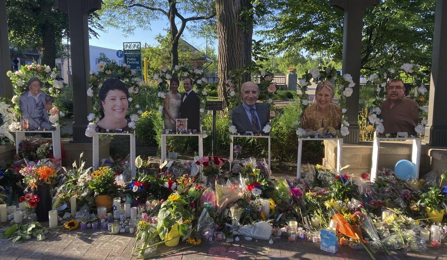 Flowers are placed at a memorial for the seven people killed in Monday's Fourth of July mass shooting, Saturday, July 9, 2022, in Highland Park, Ill. (AP Photo/Roger Schneider)