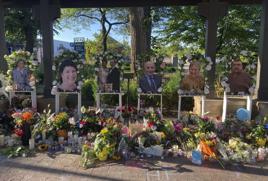 Flowers are placed at a memorial for the seven people killed in Monday's Fourth of July mass shooting, Saturday, July 9, 2022, in Highland Park, Ill. (AP Photo/Roger Schneider)