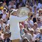 Kazakhstan&#x27;s Elena Rybakina kisses the trophy as she celebrates after beating Tunisia&#x27;s Ons Jabeur to win the final of the women&#x27;s singles on day thirteen of the Wimbledon tennis championships in London, Saturday, July 9, 2022. (AP Photo/Kirsty Wigglesworth)