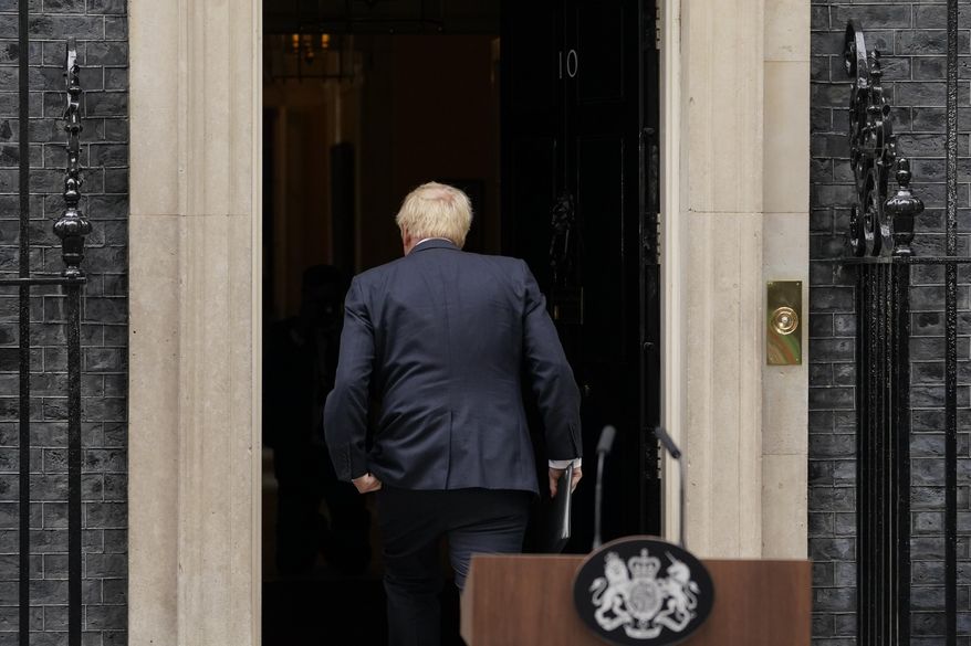 FILE - Prime Minister Boris Johnson enters 10 Downing Street, after his reading a resignation statement in London, July 7, 2022. Outgoing U.K. Prime Minister Boris Johnson has been the bane of Brussels for many years, from his days stoking anti-European Union sentiment with exaggerated newspaper stories to his populist campaign leading Britain out of the bloc and reneging on the post-Brexit trade deal he himself signed. (AP Photo/Alberto Pezzali, file)