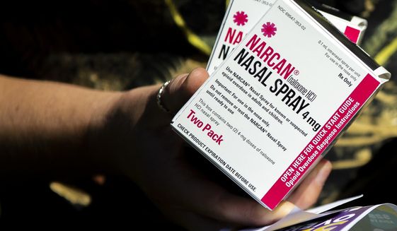 Em Ford holds boxes of Narcan, a medicine that is used in the case of opioid overdose, in Fredericksburg, Va., on Saturday, Jun. 18, 2022. The Popes said they were honored when Zoe Freedom Center, a faith-based recovery program in Spotsylvania, recently launched a Mobile Harm Reduction Unit, or “Narcan van,” in memory of Lauren Pope, who was 26 when she died after snorting heroin laced with fentanyl. (Tristan Lorei/The Free Lance-Star via AP) **FILE**