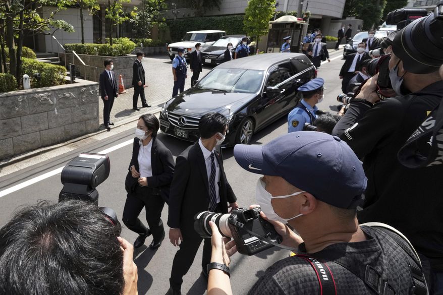 A car which is believed to carry the body of former Prime Minister Shinzo Abe, arrives at his home Saturday, July 9, 2022, in Tokyo. (AP Photo/Eugene Hoshiko)