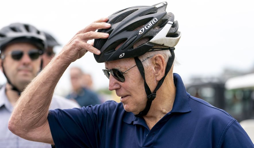 President Joe Biden speaks to members of the media as he goes on a bike ride in Gordons Pond State Park in Rehoboth Beach, Del., Sunday, July 10, 2022. (AP Photo/Andrew Harnik)