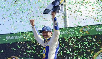 Chase Elliott (9) reacts in Victory Lane after winning the NASCAR Cup Series auto race at Atlanta Motor Speedway, Sunday, July 10, 2022, in Hampton, Ga. (AP Photo/John Bazemore)